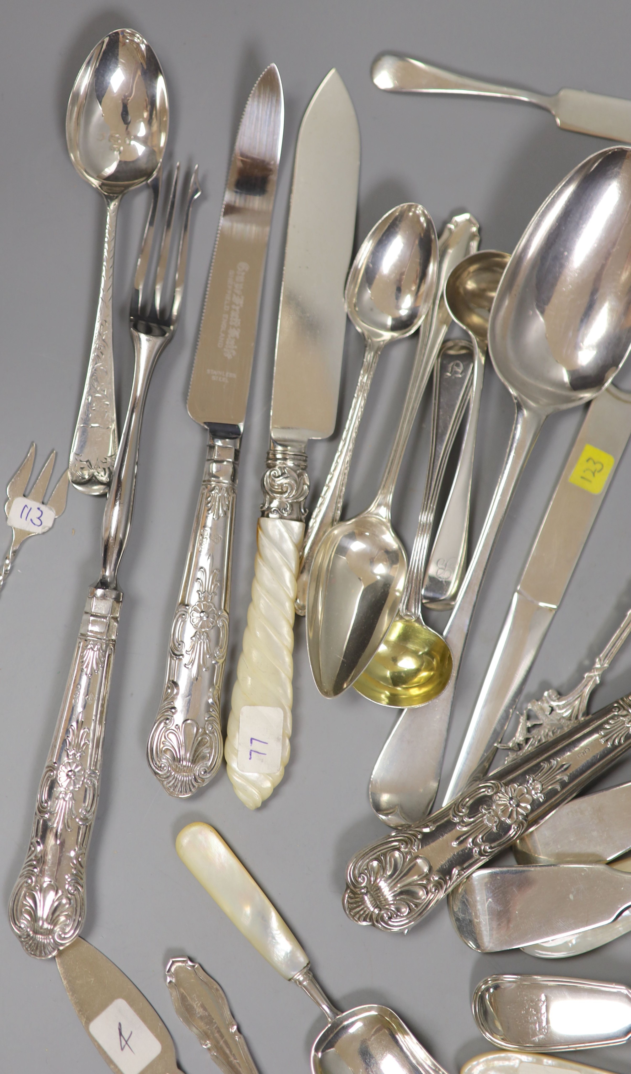 Four Victorian and later silver butter knives including Newcastle and a group of assorted silver flatware including two 19th century caddy spoons, tablespoons, letter opener and a Victorian agate handled butter knife.